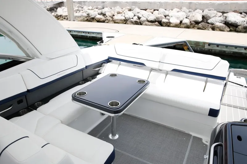 Slide: The Image of Manufacturer Provided Image: 2021 Formula 350 Sun Sport boat interior with seating and table at dock. - 58