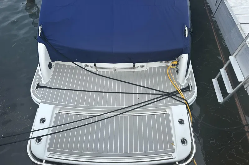 Slide: The Image of 2021 Formula 350 Sun Sport boat docked with blue cover and power cables. - 6