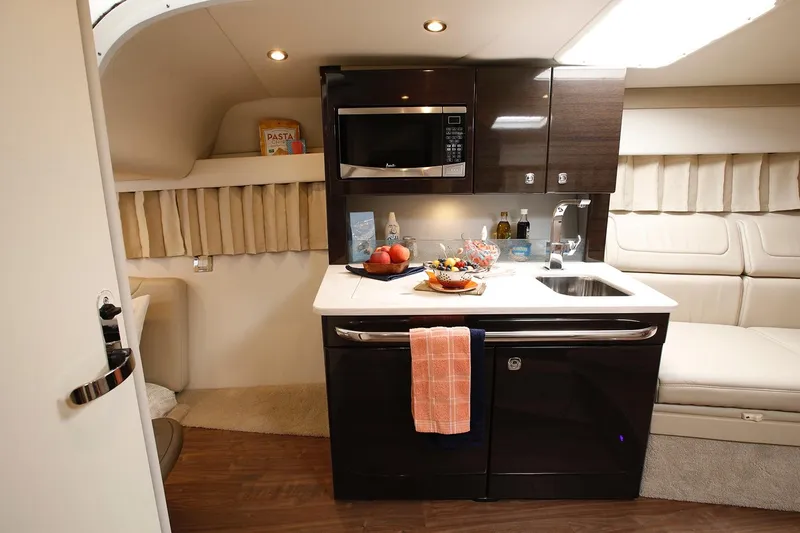 Slide: The Image of Manufacturer Provided Image: 2021 Formula 350 Sun Sport interior kitchen with microwave, sink, and countertop. - 65