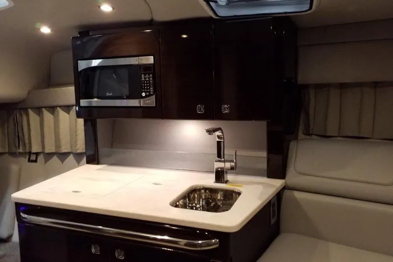 Slide: The Image of 2021 Formula 350 Sun Sport interior with kitchenette, featuring a microwave and sink. - 67