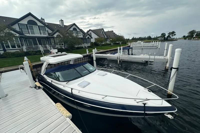 Slide: The Image of 2021 Formula 350 Sun Sport docked near waterfront homes under cloudy skies. - 68