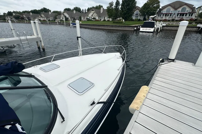 Slide: The Image of 2021 Formula 350 Sun Sport docked at a marina with waterfront homes. - 69