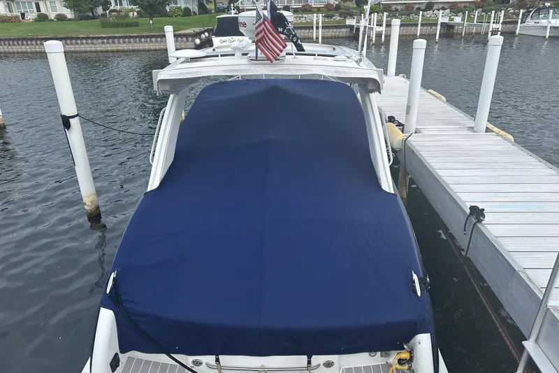 Slide: The Image of 2021 Formula 350 Sun Sport boat docked with blue cover, American flag displayed. - 7