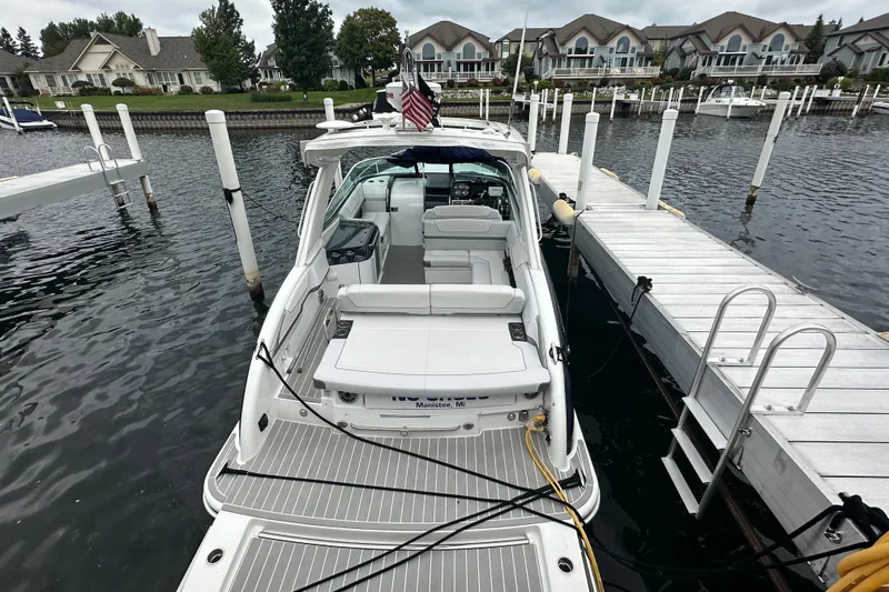 Slide: The Image of 2021 Formula 350 Sun Sport docked at marina, surrounded by waterfront homes. - 8