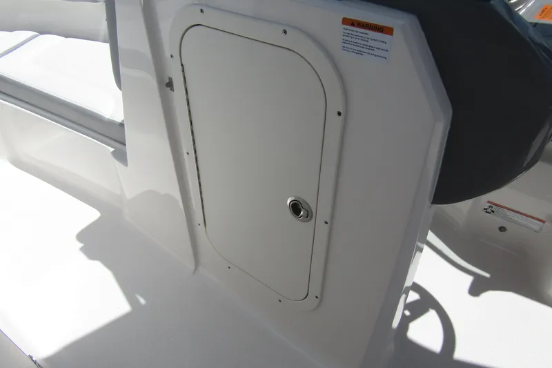Slide: The Image of 2022 Chaparral 23 SSi boat interior storage compartment with sleek white finish. - 12