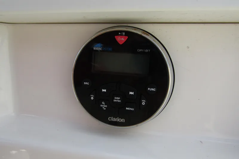 Slide: The Image of Clarion marine audio system on 2022 Chaparral 23 SSi boat dashboard. - 15
