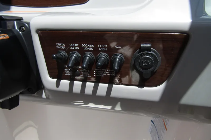 Slide: The Image of Control panel of 2022 Chaparral 23 SSi boat with switches and 12V outlet. - 21