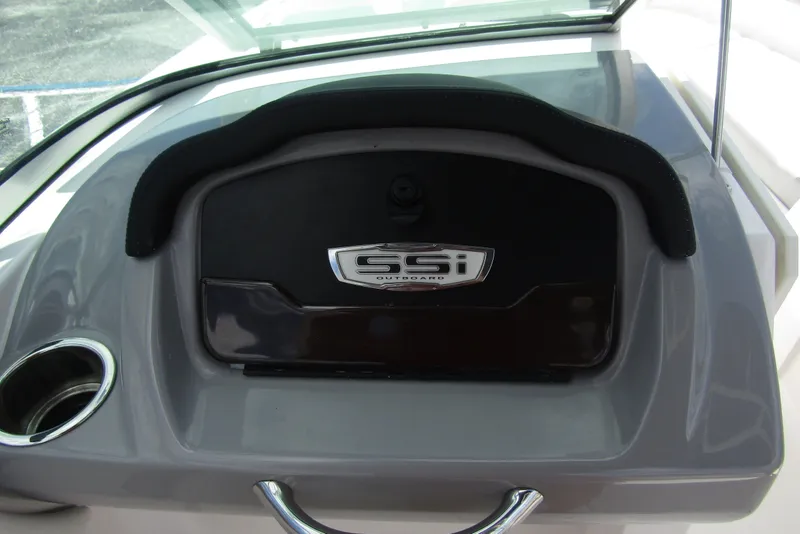 Slide: The Image of 2022 Chaparral 23 SSi dashboard with cup holder and storage compartment. - 23