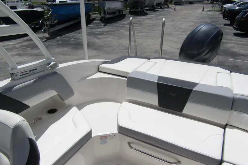 Slide: The Image of 2022 Chaparral 23 SSi boat interior with white seating and sleek design. - 26