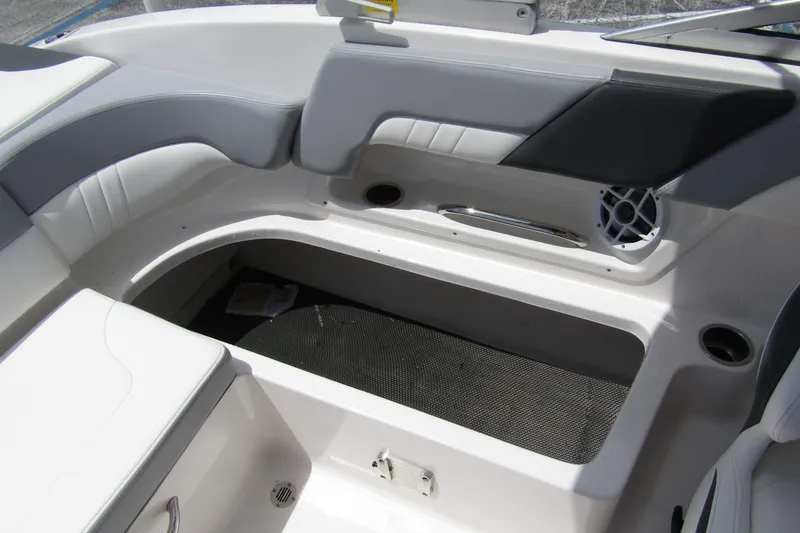 Slide: The Image of 2022 Chaparral 23 SSi boat interior with seating and storage compartment. - 27