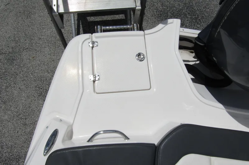 Slide: The Image of 2022 Chaparral 23 SSi boat deck with storage compartment and ladder. - 29