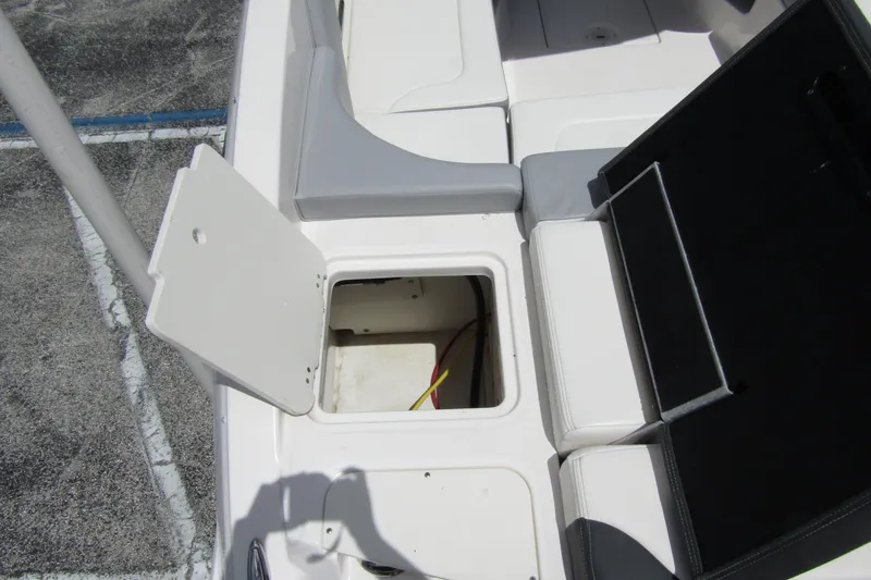 Slide: The Image of 2022 Chaparral 23 SSi boat interior storage compartment with open hatch. - 32