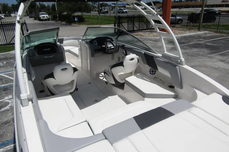 Slide: The Image of 2022 Chaparral 23 SSi boat interior with seating and steering console. - 35