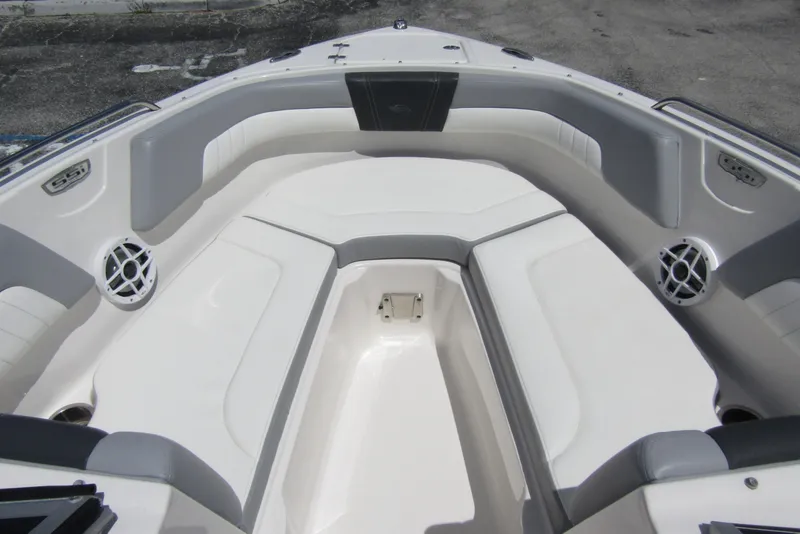 Slide: The Image of 2022 Chaparral 23 SSi boat interior with white and gray seating, featuring speakers. - 8