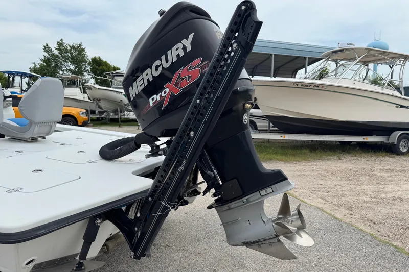 Slide: The Image of 2006 Majek 22 Extreme boat with Mercury Pro XS outboard motor in a marina setting. - 10