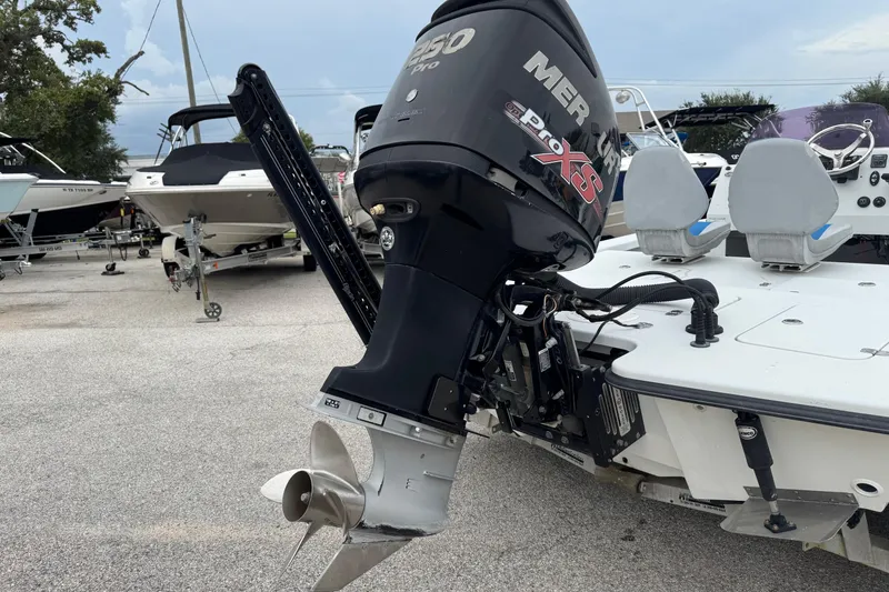 Slide: The Image of 2006 Majek 22 Extreme boat with Mercury Pro XS outboard motor in a marina. - 11
