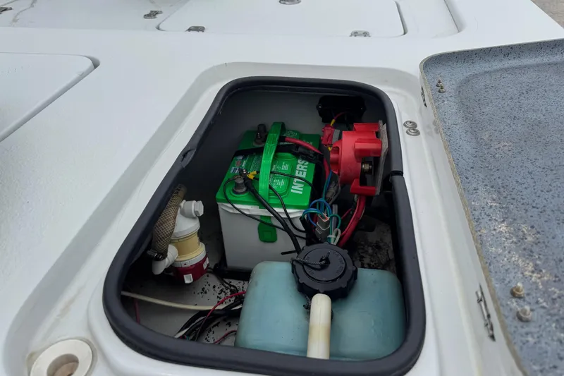 Slide: The Image of Battery compartment of a 2006 Majek 22 Extreme boat, showing wiring and components. - 12