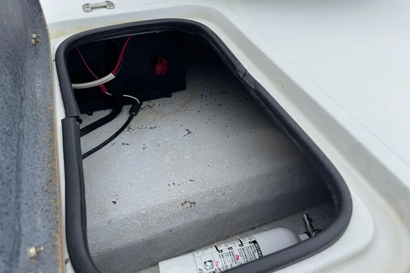 Slide: The Image of Storage compartment of a 2006 Majek 22 Extreme boat with wiring and fire extinguisher. - 13