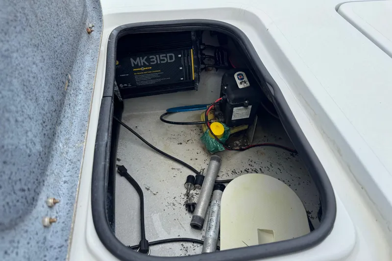 Slide: The Image of 2006 Majek 22 Extreme boat compartment with battery and charger setup. - 9