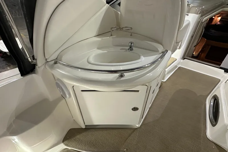 Slide: The Image of 2004 Sea Ray 340 Sundancer boat interior with sink and storage area. - 10