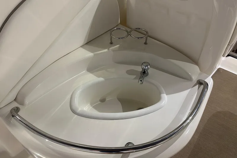 Slide: The Image of 2004 Sea Ray 340 Sundancer bathroom sink with chrome fixtures and cup holders. - 11