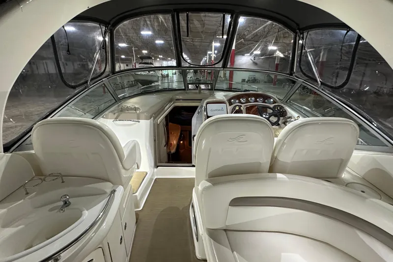 Slide: The Image of Interior of 2004 Sea Ray 340 Sundancer yacht with helm and seating area. - 14