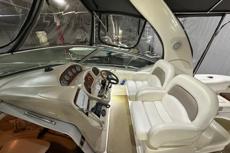 Slide: The Image of Interior cockpit of 2004 Sea Ray 340 Sundancer with dual seats and navigation equipment. - 15