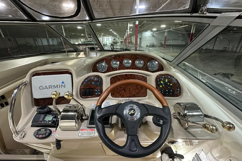 Slide: The Image of 2004 Sea Ray 340 Sundancer helm with Garmin navigation and wood-accented dashboard. - 18