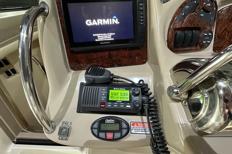 Slide: The Image of Control panel of a 2004 Sea Ray 340 Sundancer with Garmin and VHF radio. - 22