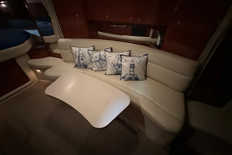 Slide: The Image of Luxurious 2004 Sea Ray 340 Sundancer cabin with elegant seating and nautical-themed cushions. - 27