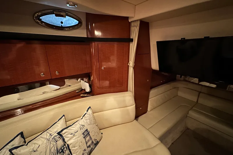 Slide: The Image of Luxurious interior of 2004 Sea Ray 340 Sundancer yacht with plush seating and elegant wood finishes. - 30
