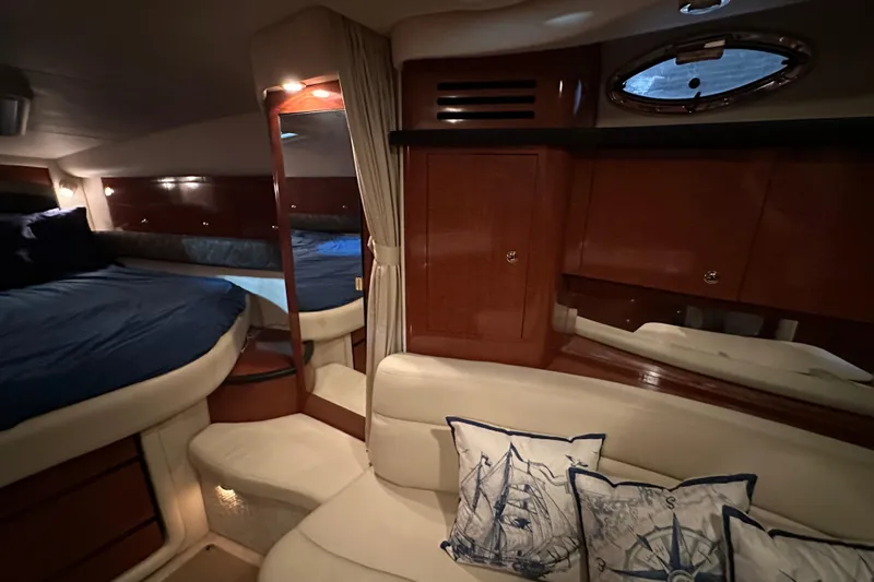 Slide: The Image of Luxurious interior of 2004 Sea Ray 340 Sundancer with cozy seating and nautical-themed pillows. - 31