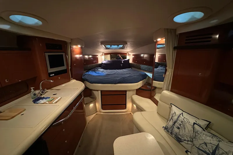 Slide: The Image of Luxurious interior of 2004 Sea Ray 340 Sundancer yacht with cozy bed and kitchenette. - 38