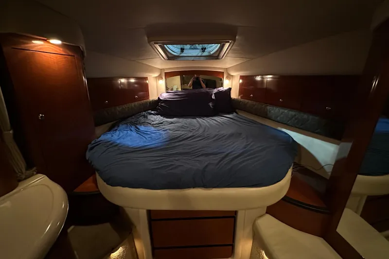 Slide: The Image of Luxurious cabin interior of 2004 Sea Ray 340 Sundancer with cozy bed and ambient lighting. - 39