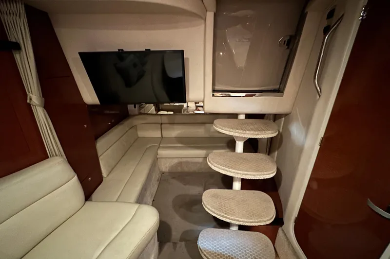 Slide: The Image of Interior of 2004 Sea Ray 340 Sundancer with TV, seating, and spiral stairs. - 45