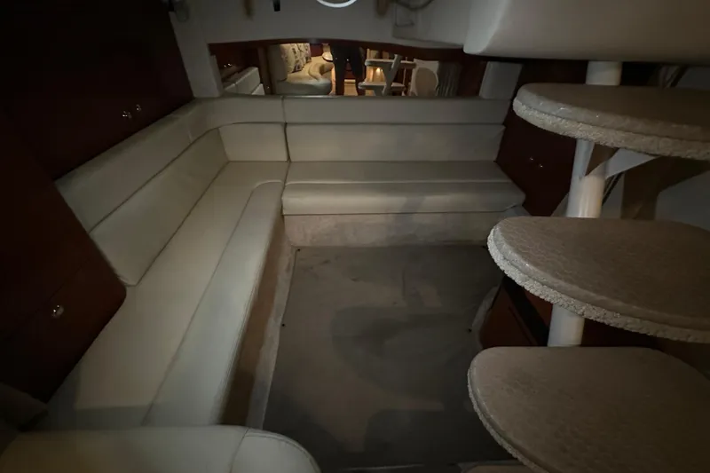 Slide: The Image of Interior of 2004 Sea Ray 340 Sundancer with beige seating and spiral staircase. - 46