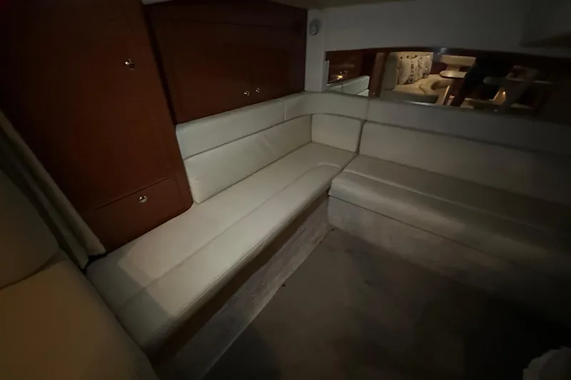 Slide: The Image of Interior of 2004 Sea Ray 340 Sundancer with beige seating and wooden cabinetry. - 47