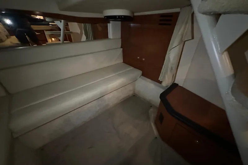 Slide: The Image of 2004 Sea Ray 340 Sundancer cabin interior with seating and wooden cabinetry. - 48