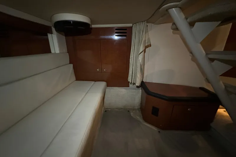 Slide: The Image of Interior of 2004 Sea Ray 340 Sundancer with seating and wooden cabinetry. - 49