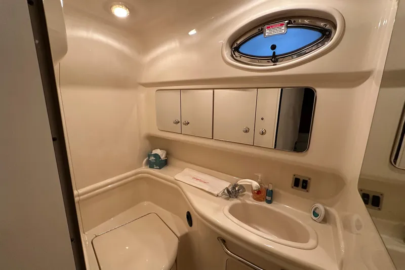 Slide: The Image of Bathroom interior of 2004 Sea Ray 340 Sundancer yacht, featuring sink and storage cabinets. - 51