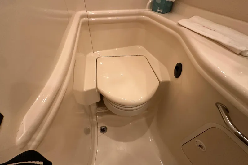 Slide: The Image of Compact bathroom in 2004 Sea Ray 340 Sundancer yacht, featuring a marine toilet. - 53