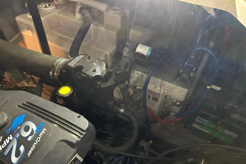 Slide: The Image of Engine compartment of a 2004 Sea Ray 340 Sundancer boat, featuring a MerCruiser 6.2 engine. - 56