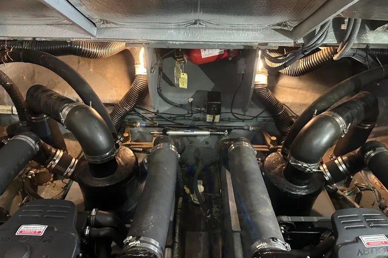 Slide: The Image of Engine room of a 2004 Sea Ray 340 Sundancer with visible hoses and components. - 57