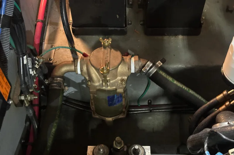 Slide: The Image of Engine compartment of 2004 Sea Ray 340 Sundancer with visible hoses and wiring. - 58