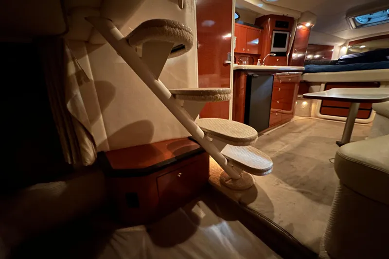 Slide: The Image of Interior of 2004 Sea Ray 340 Sundancer yacht with stairs, kitchenette, and seating area. - 64
