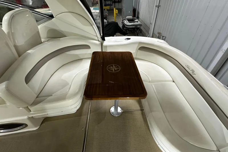 Slide: The Image of 2004 Sea Ray 340 Sundancer interior with elegant seating and wooden table. - 7