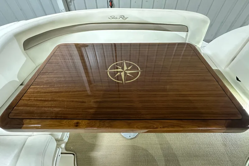 Slide: The Image of Polished wooden table with compass design on 2004 Sea Ray 340 Sundancer boat. - 9
