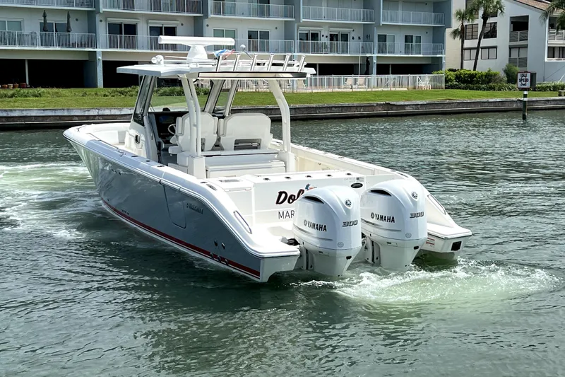 Slide: The Image of 2020 Pursuit S 328 Sport boat with twin Yamaha engines on a calm waterway. - 2