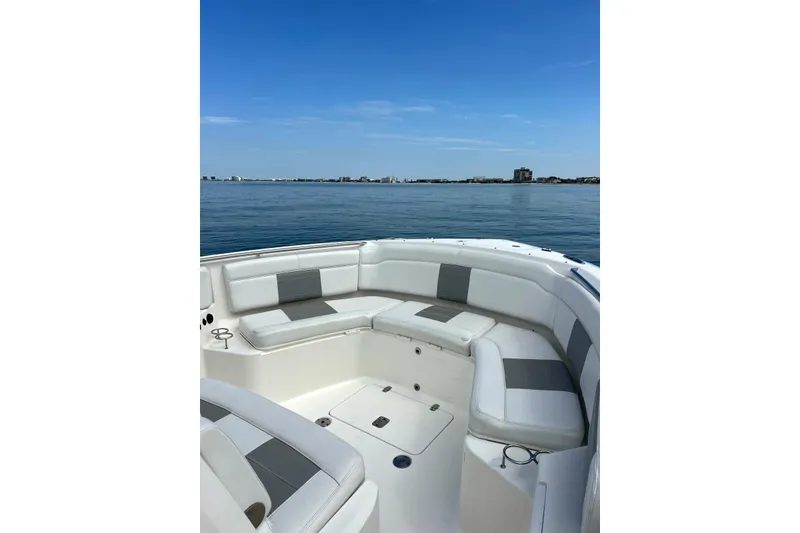 Slide: The Image of 2020 Pursuit S 328 Sport boat with spacious seating on calm water. - 26