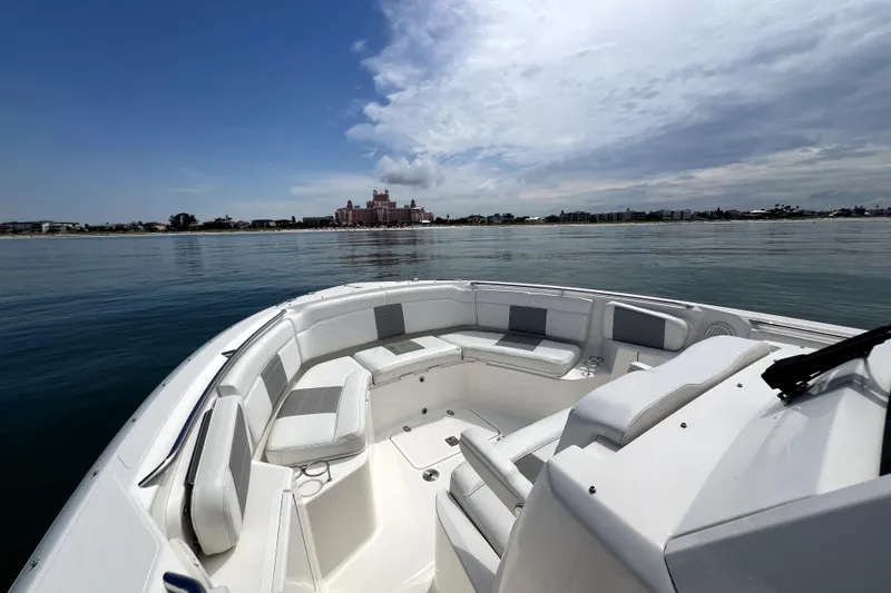 Slide: The Image of 2020 Pursuit S 328 Sport boat on calm water with scenic coastal view. - 27